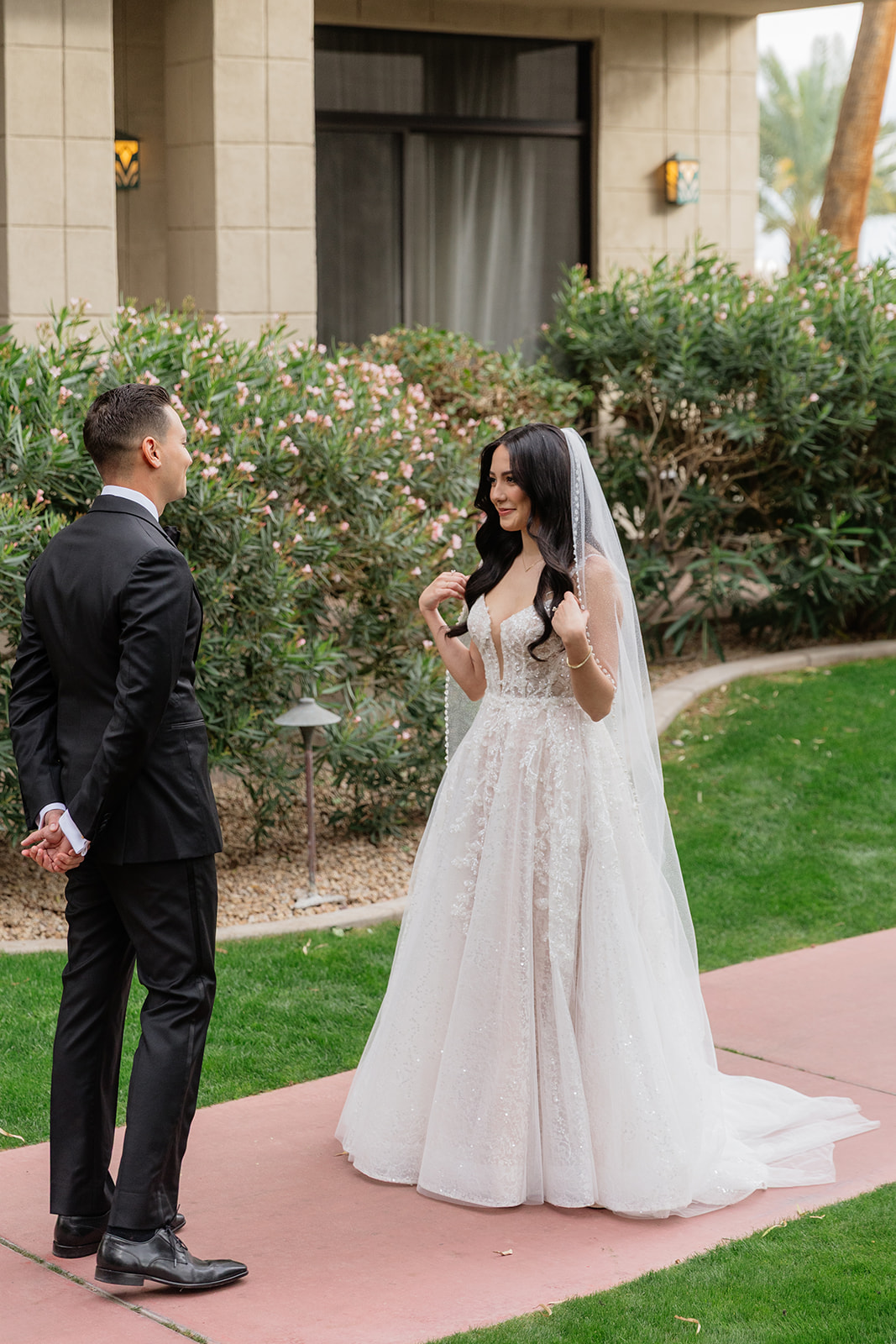 Couple seeing each other for the first time outside on a garden walkway at the Biltmore wedding venue
