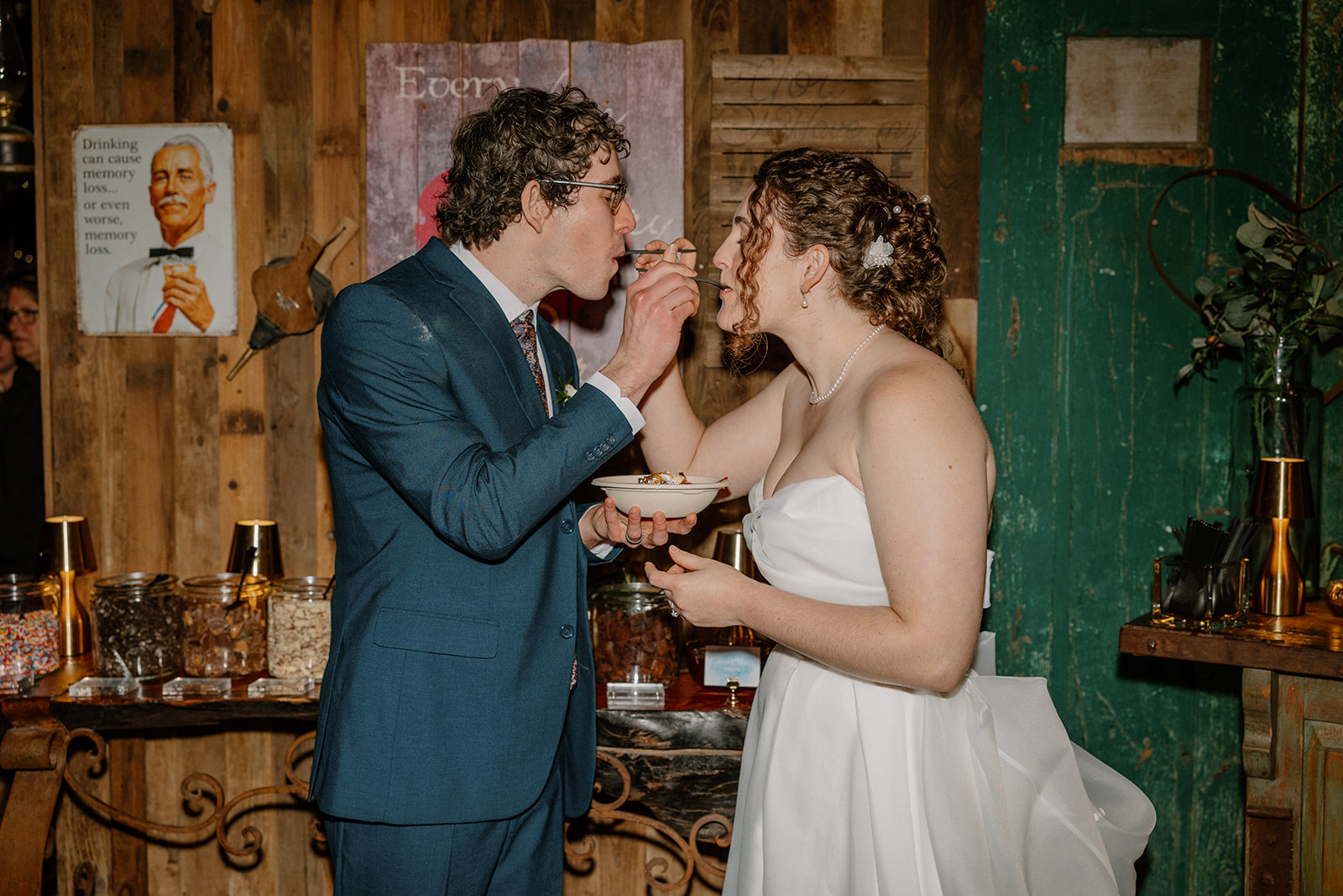 Couple sharing dessert together at rustic indoor reception space in Arizona wedding venues setting
