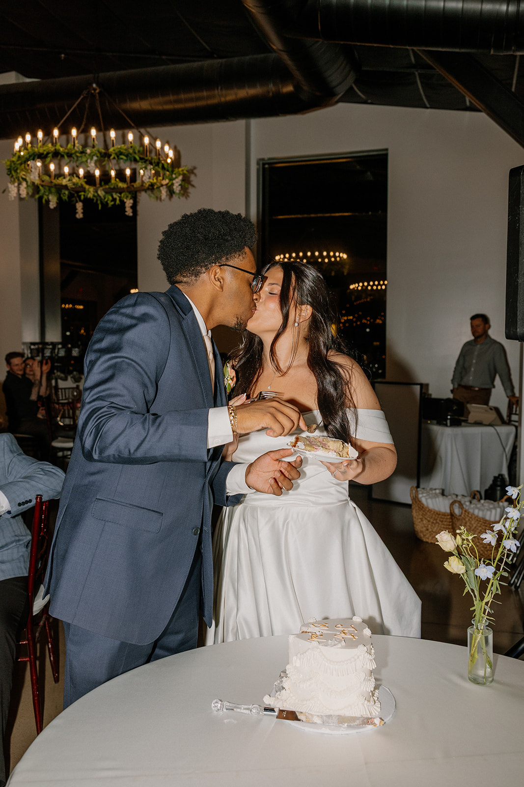 bride and groom kissing while feeding each other cake at gold canyon golf resort wedding