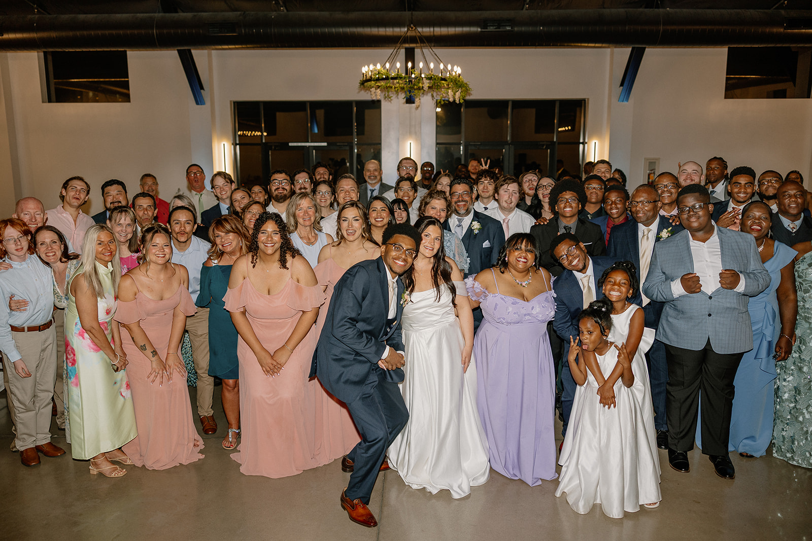 large group photo of wedding guests and wedding party during reception celebration
