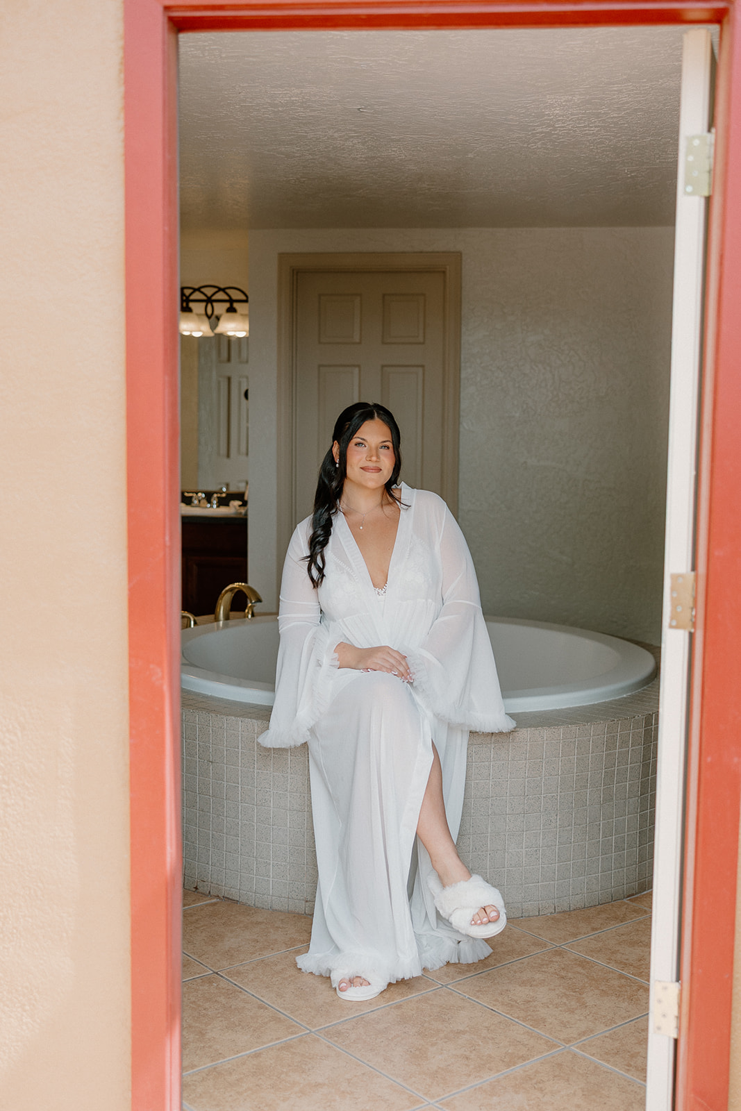 bride sitting in bathtub in hotel suite getting ready at gold canyon golf resort wedding
