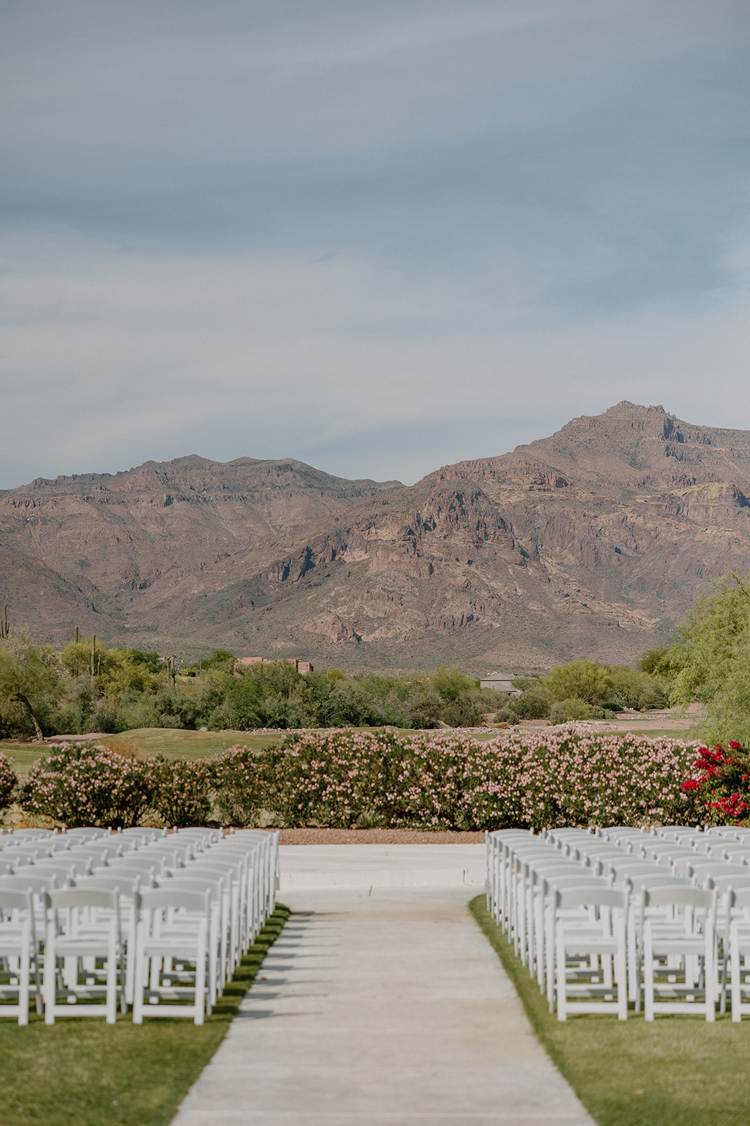 bride and groom kissing at sunset with desert landscape and soft light at gold canyon golf resort wedding