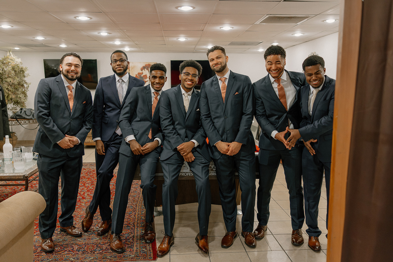 groom and groomsmen posing together indoors before ceremony at gold canyon golf resort wedding