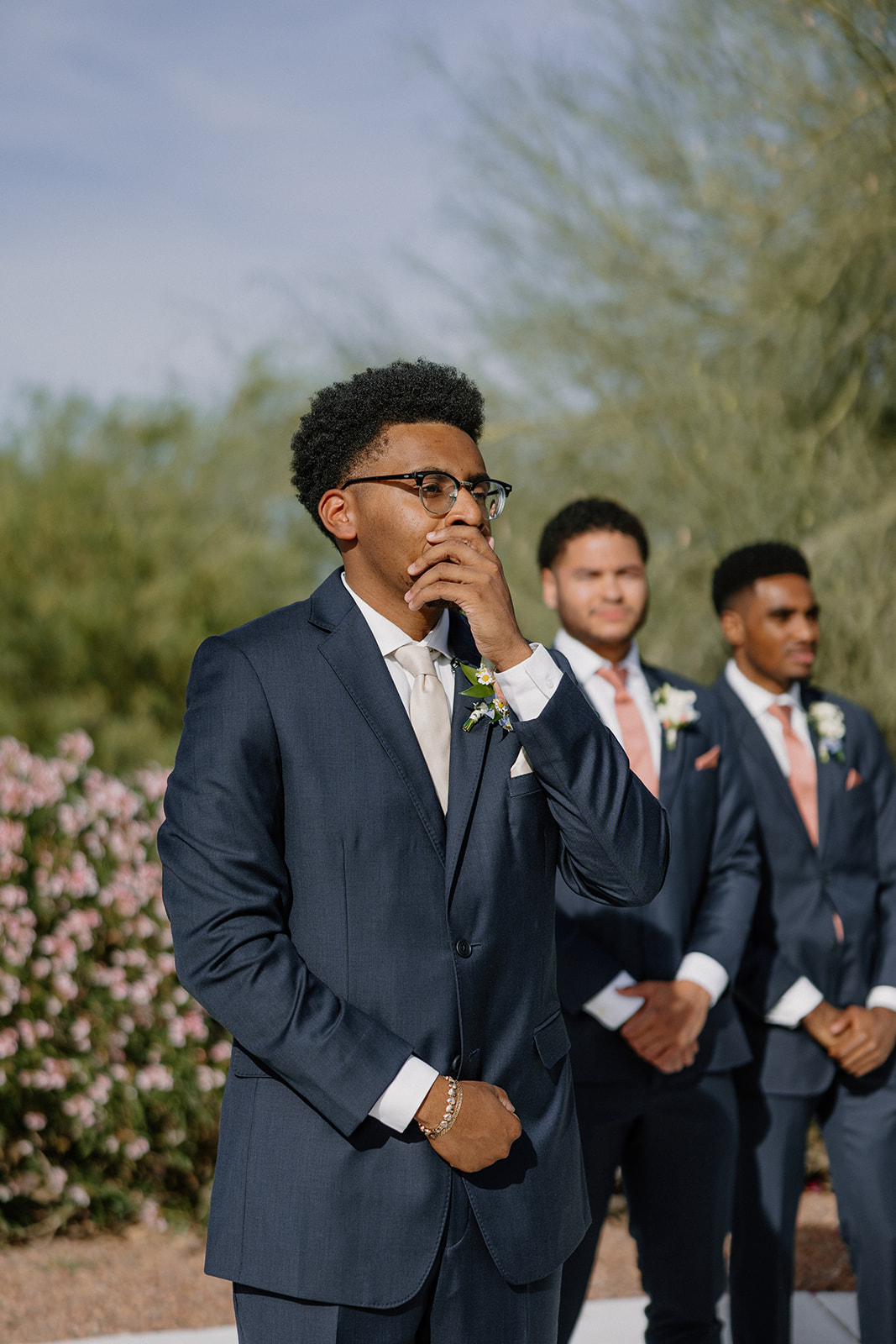 groom reacting emotionally during ceremony with groomsmen standing behind him