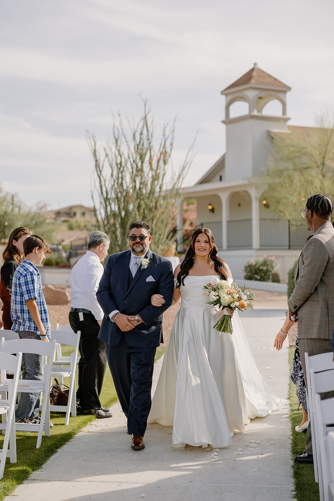 bride walking down aisle with parent during outdoor ceremony at gold canyon golf resort wedding