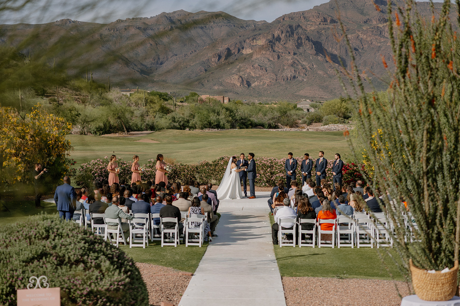 wide ceremony view with guests seated and mountains in background at gold canyon golf resort wedding