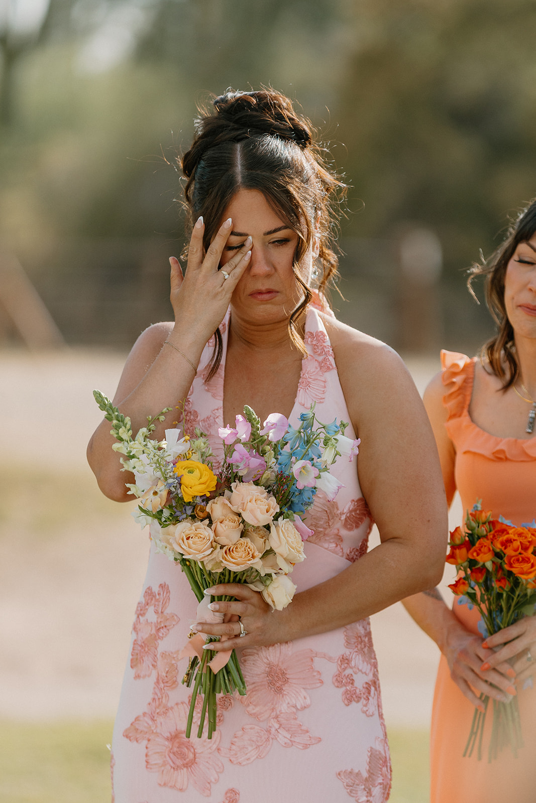 A bridesmaid crying during a wedding ceremony