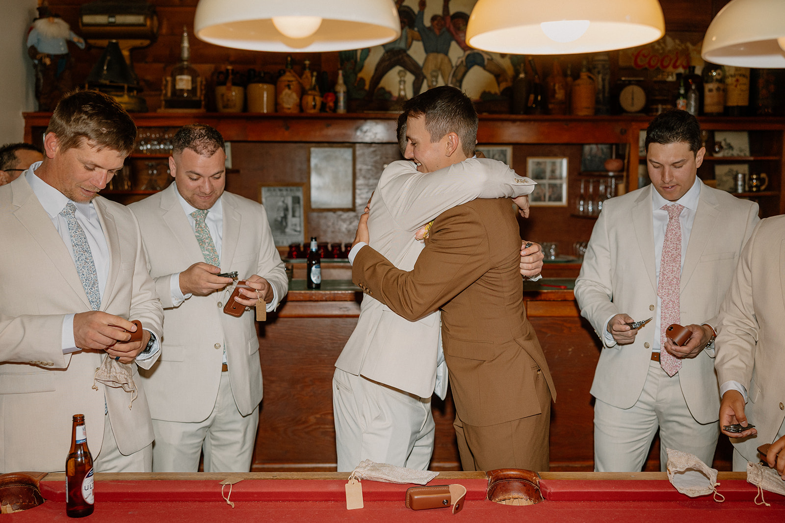 A groom hugging a groomsman 