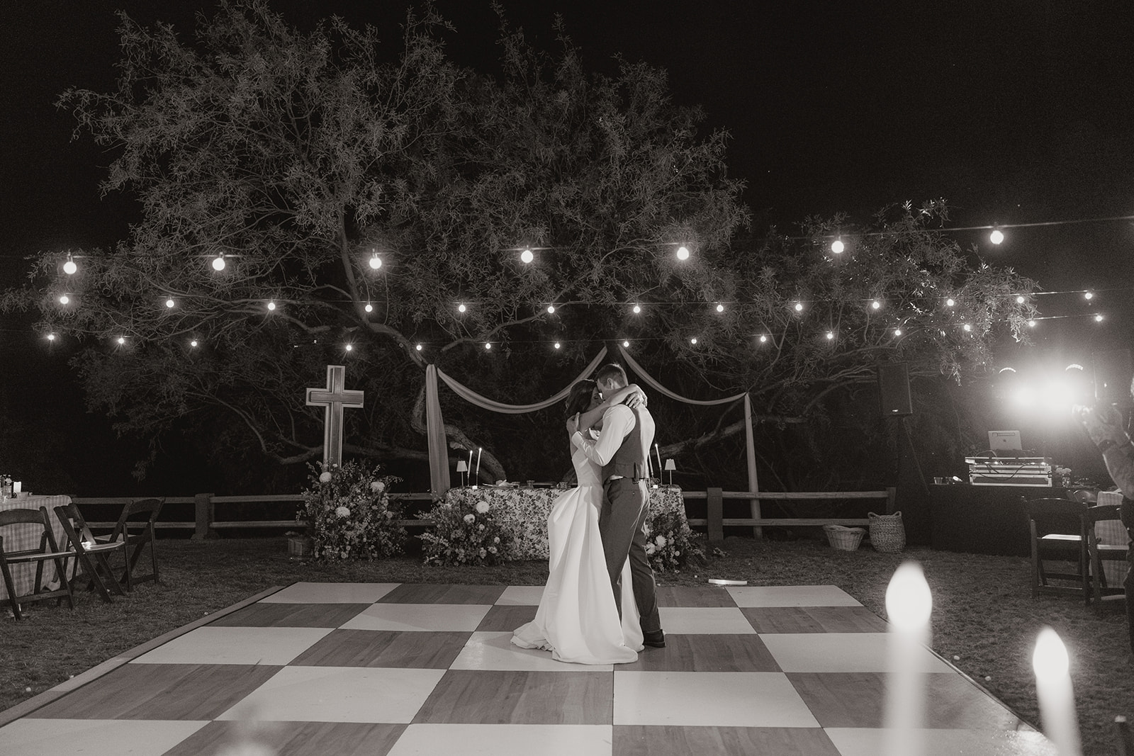A black and white photo of a bride and groom dancing at their wedding reception