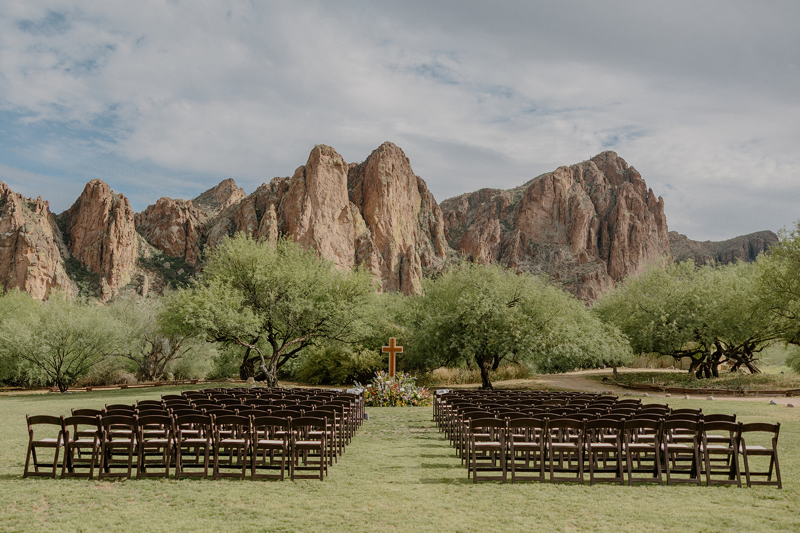 A wedding ceremony setup with a cross as a wedding detail