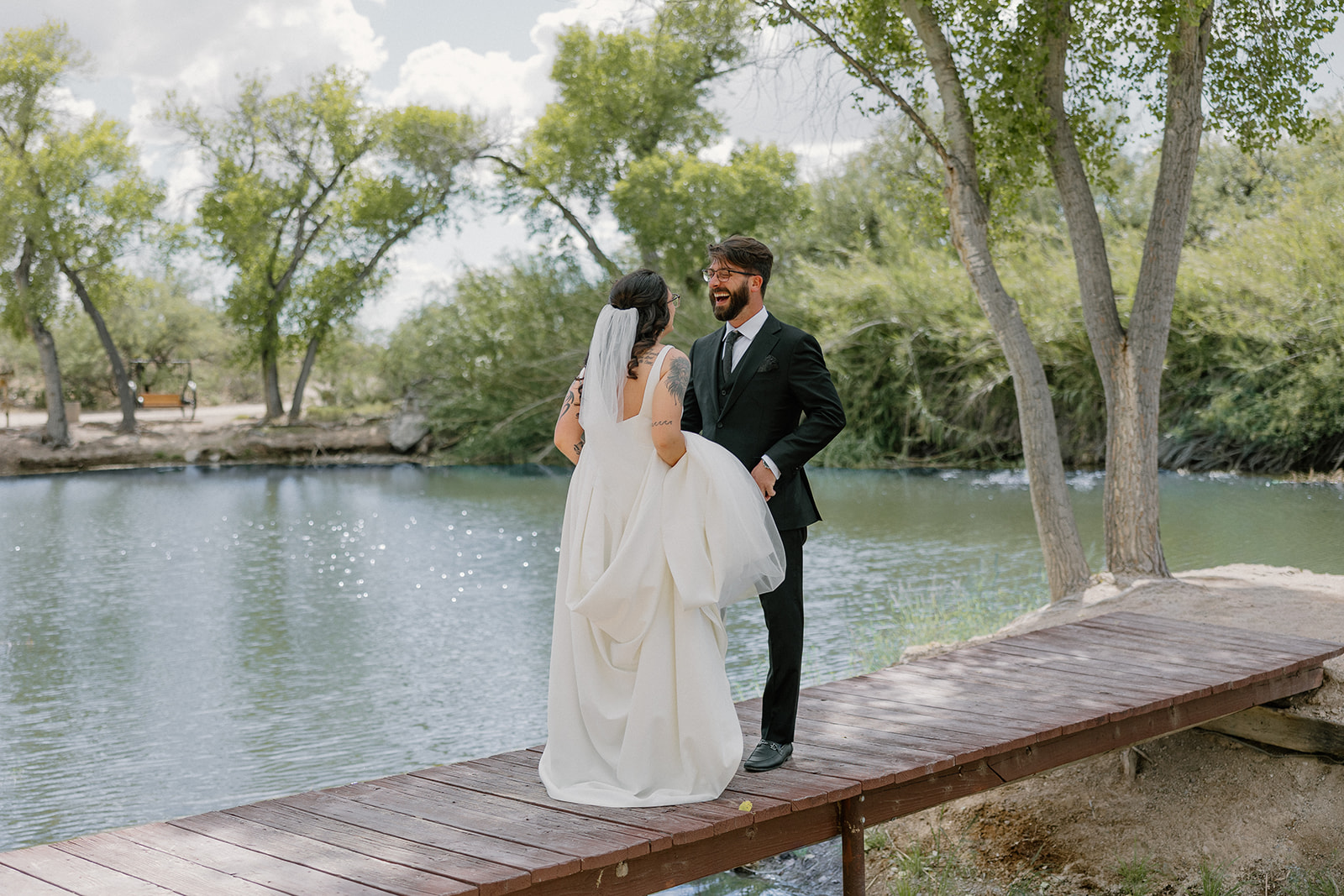 A bride and groom laughing in wedding photos