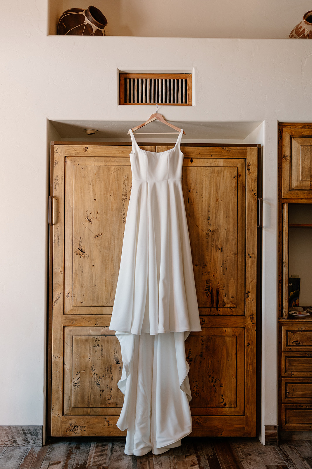 A wedding dress hanging in getting ready rooms at Tanque Verde Ranch