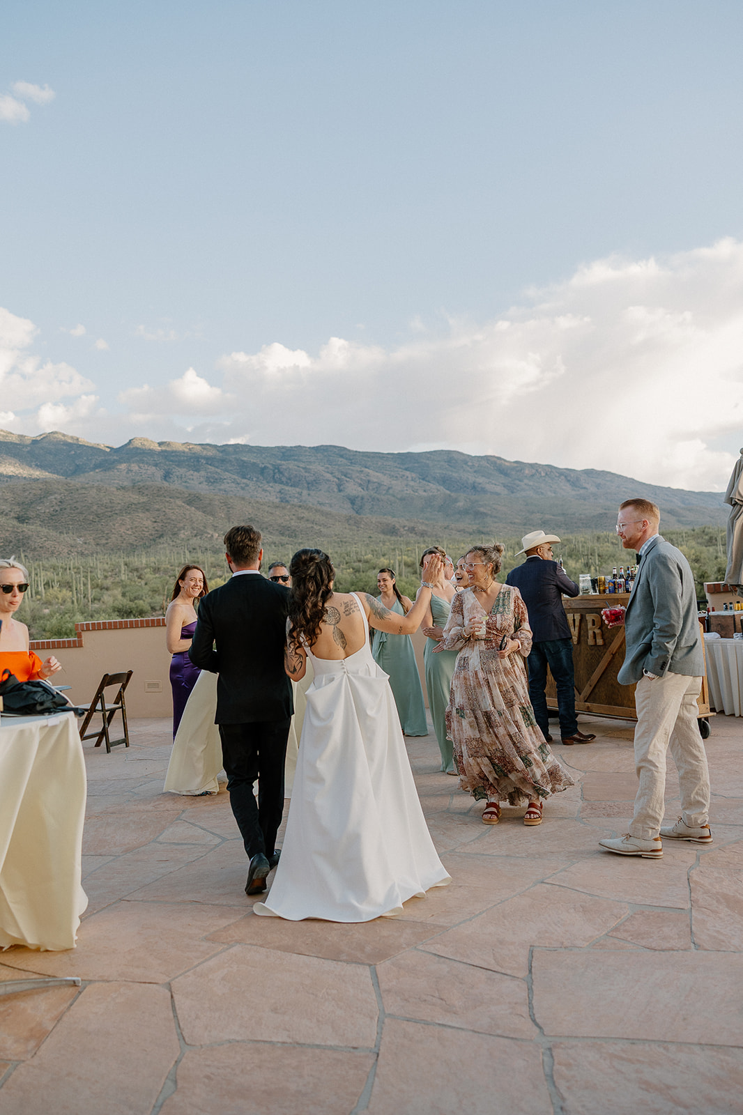 A bride and groom greeting guests at a cocktail hour