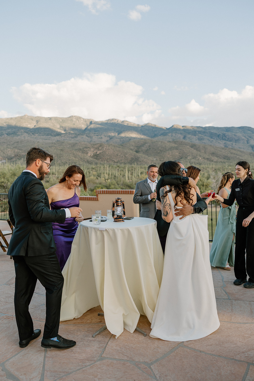 A bride and groom greeting guests at a cocktail hour