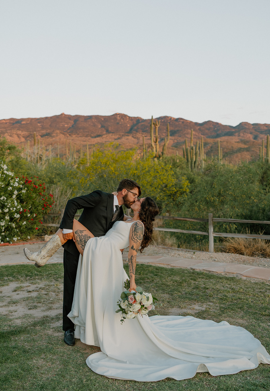 A bride and groom kissing in wedding photos