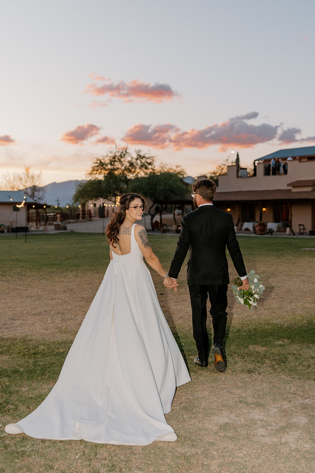 a bride and groom walking towards their intimate wedding at Tanque Verde Ranch