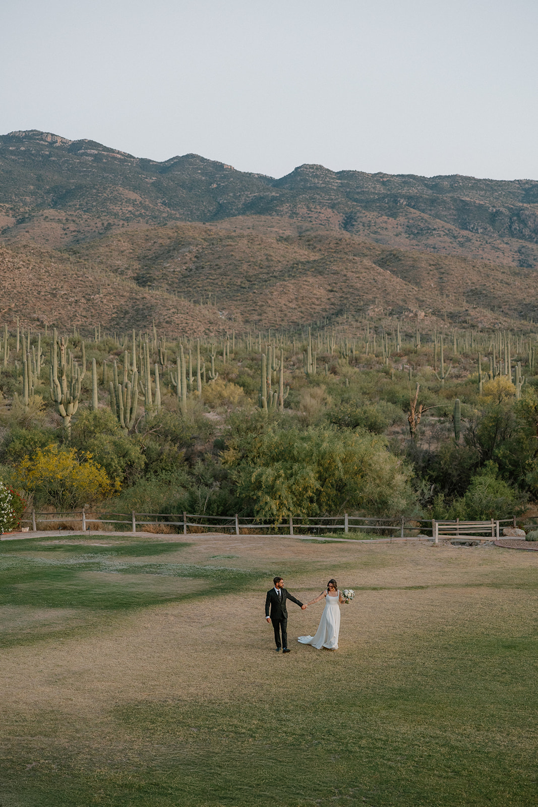 a bride and groom walking towards their intimate wedding at Tanque Verde Ranch