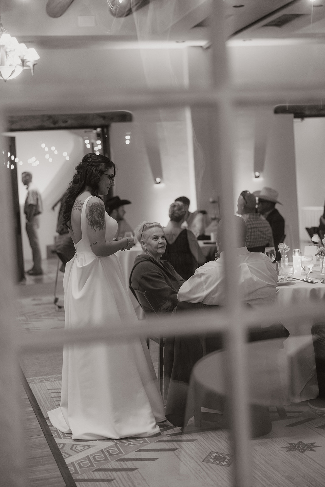 A bride talking to guests at her wedding reception