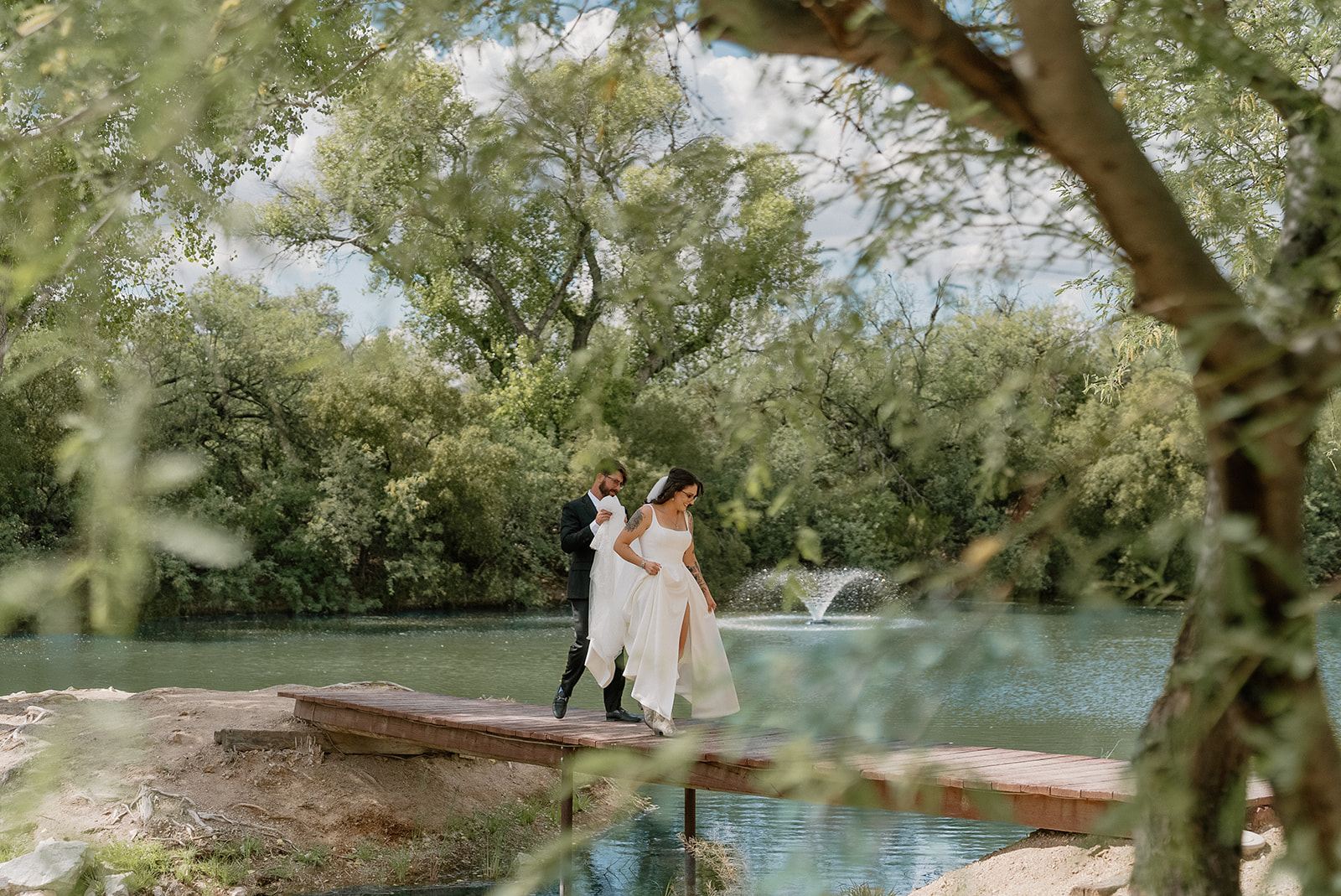 A bride and groom on a bridge
