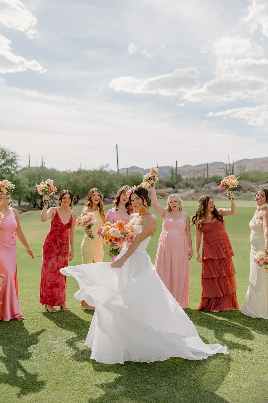 A bride taking backyard wedding photos with her bridesmaids