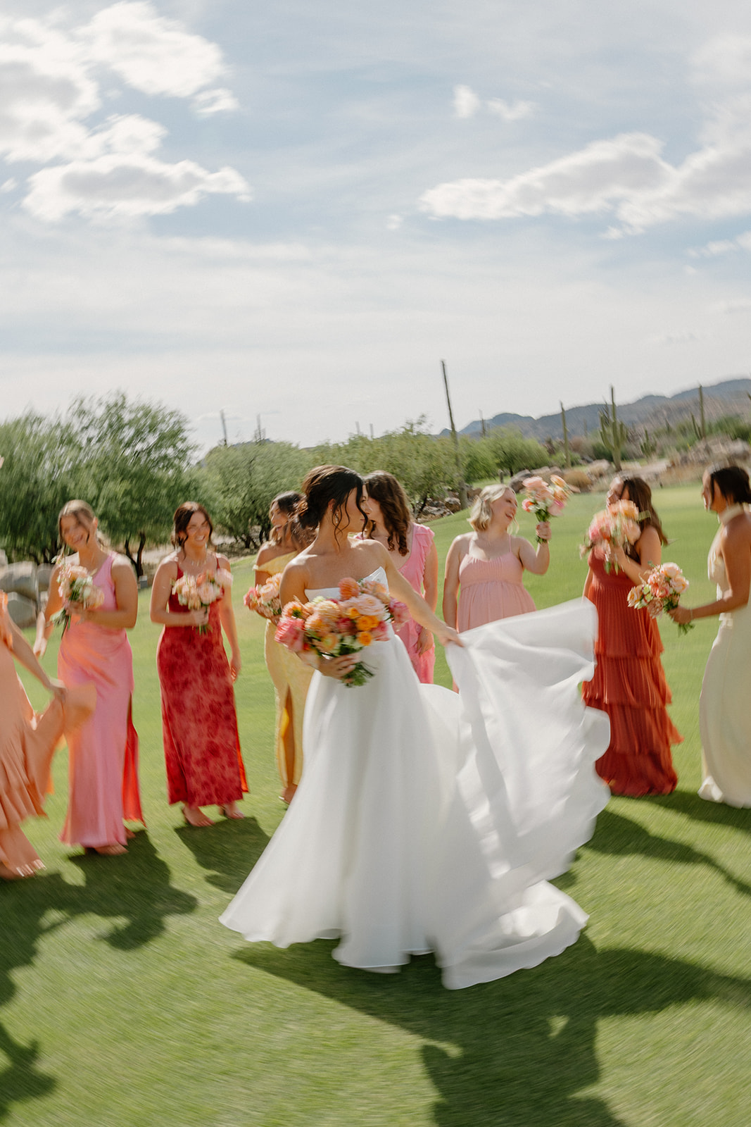 A bride taking backyard wedding photos with her bridesmaids