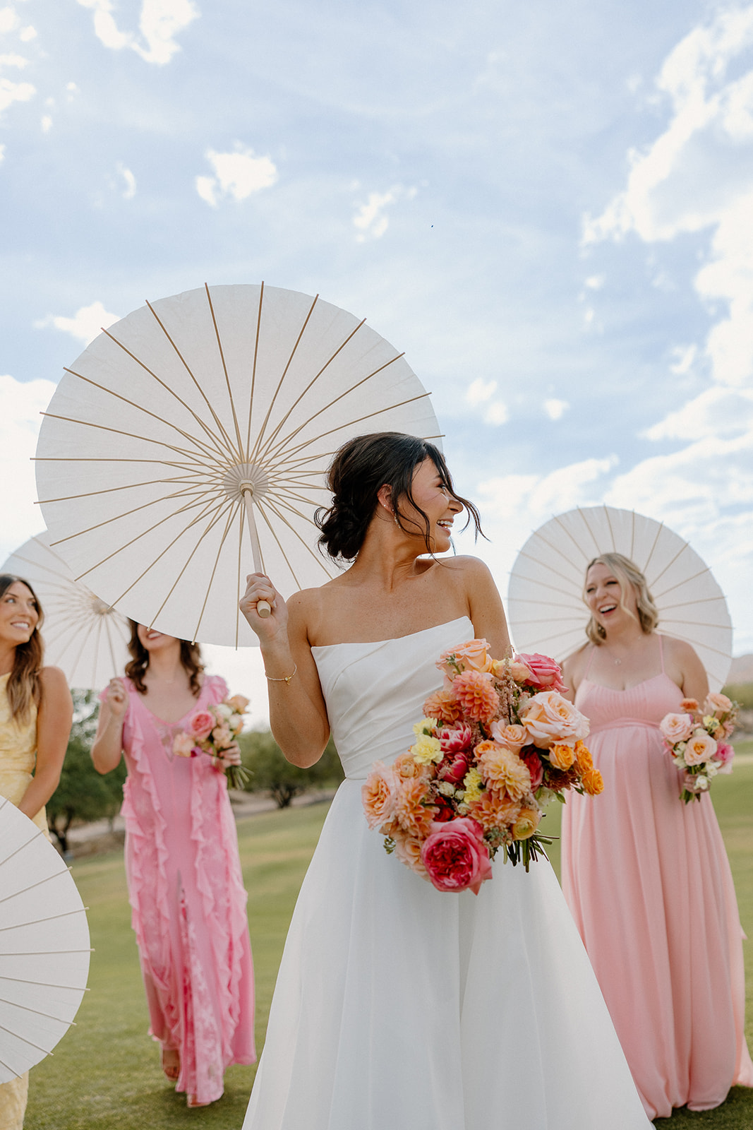 A bride taking backyard wedding photos with her bridesmaids