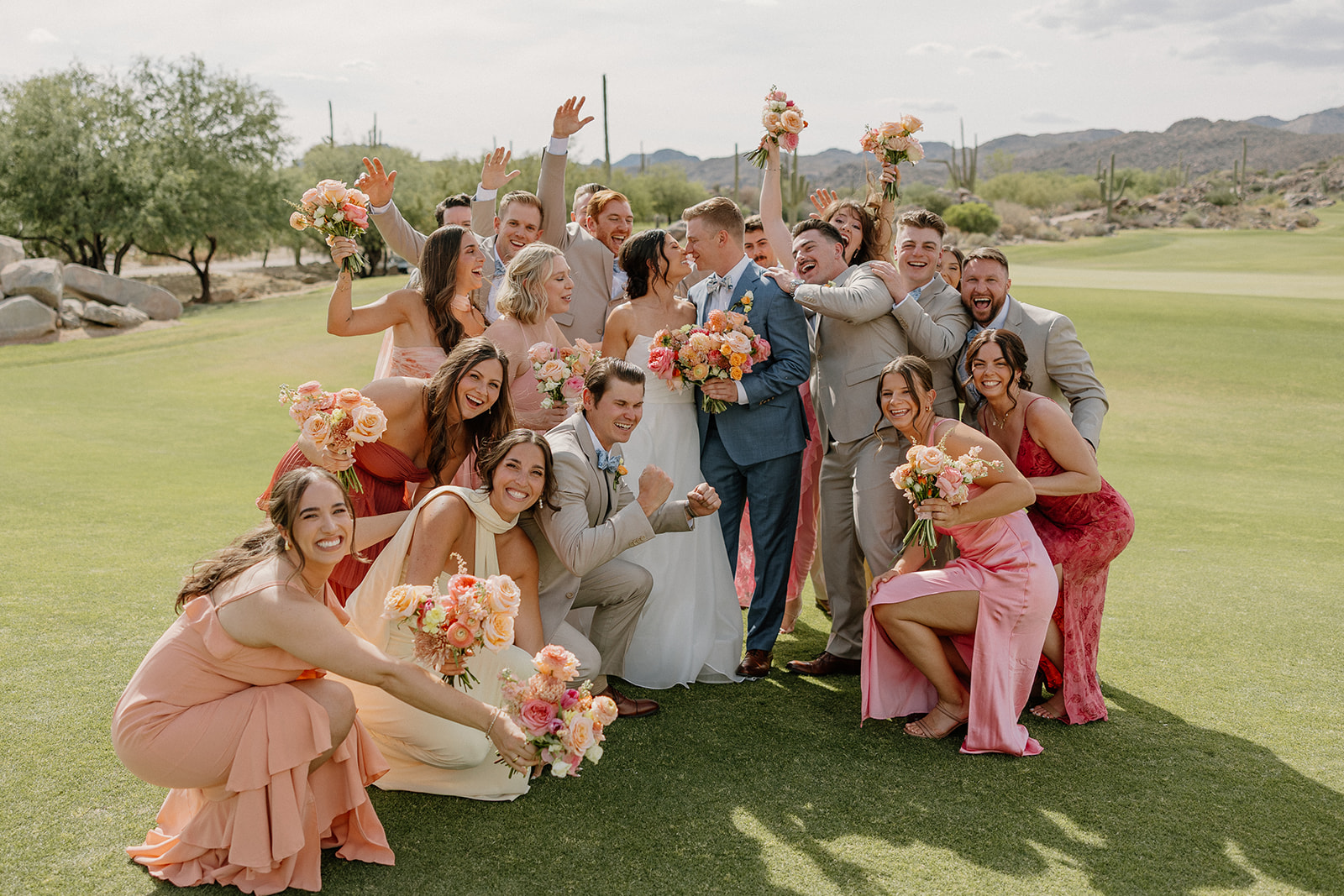 A wedding party posing for photos at a backyard wedding