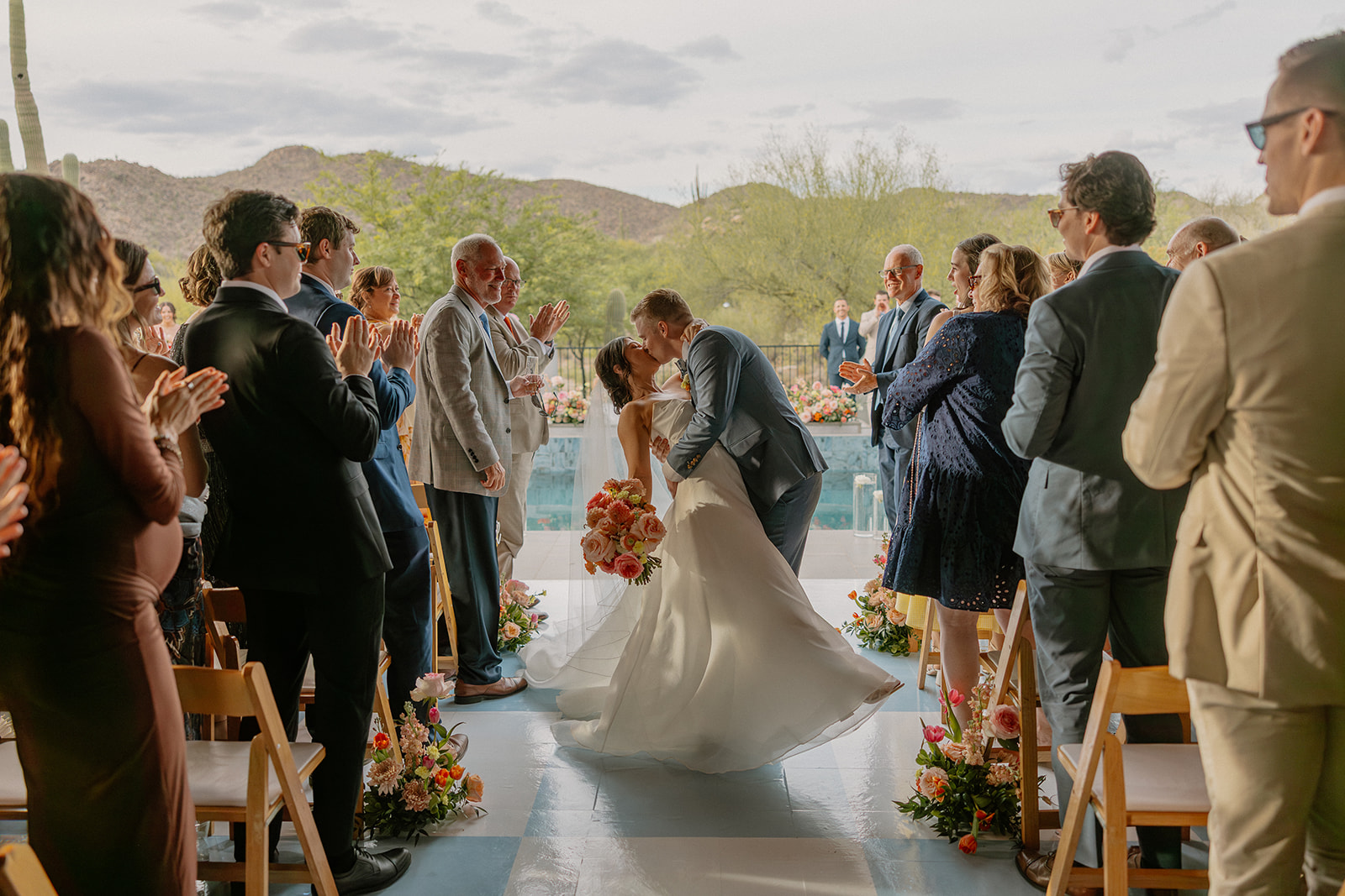 A bride and groom kissing after their wedding ceremony