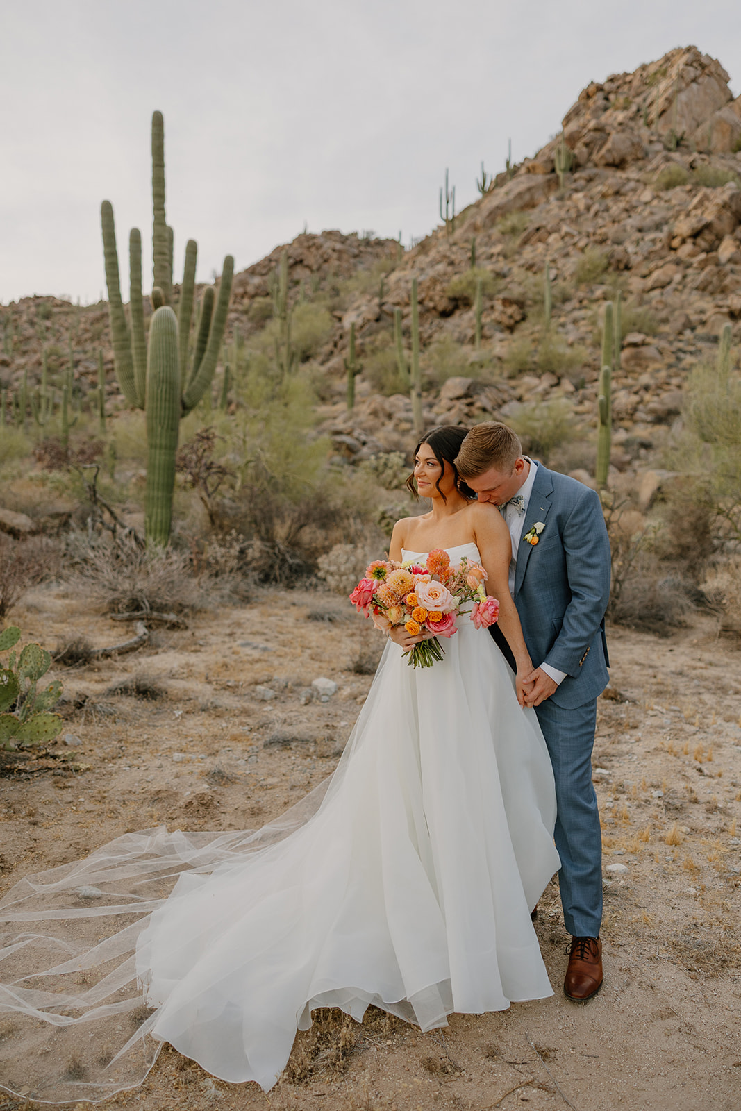 A bride and groom taking desert wedding photos in their backyard wedding
