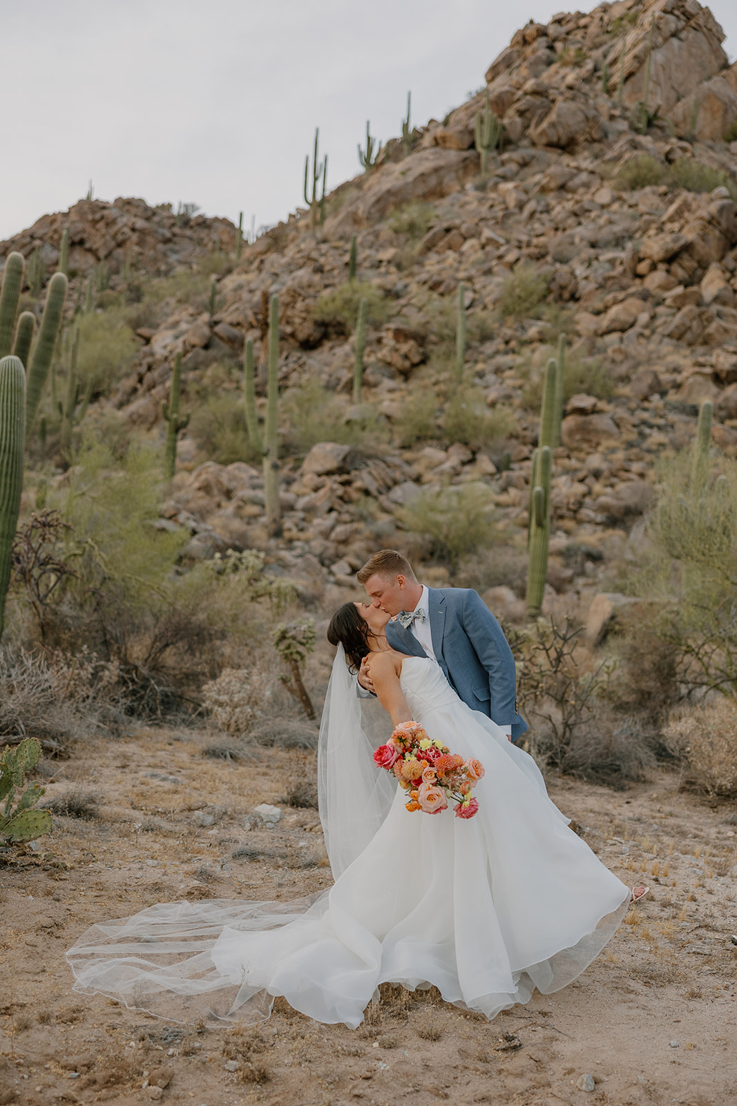A bride and groom taking desert wedding photos in their backyard wedding