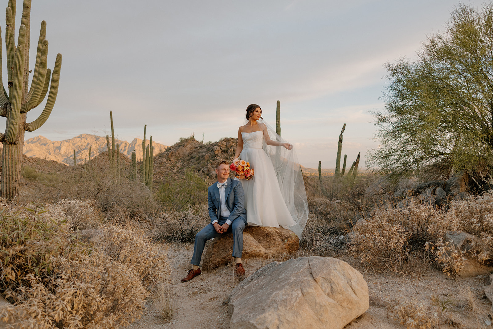 A bride and groom posing for backyard wedding photos