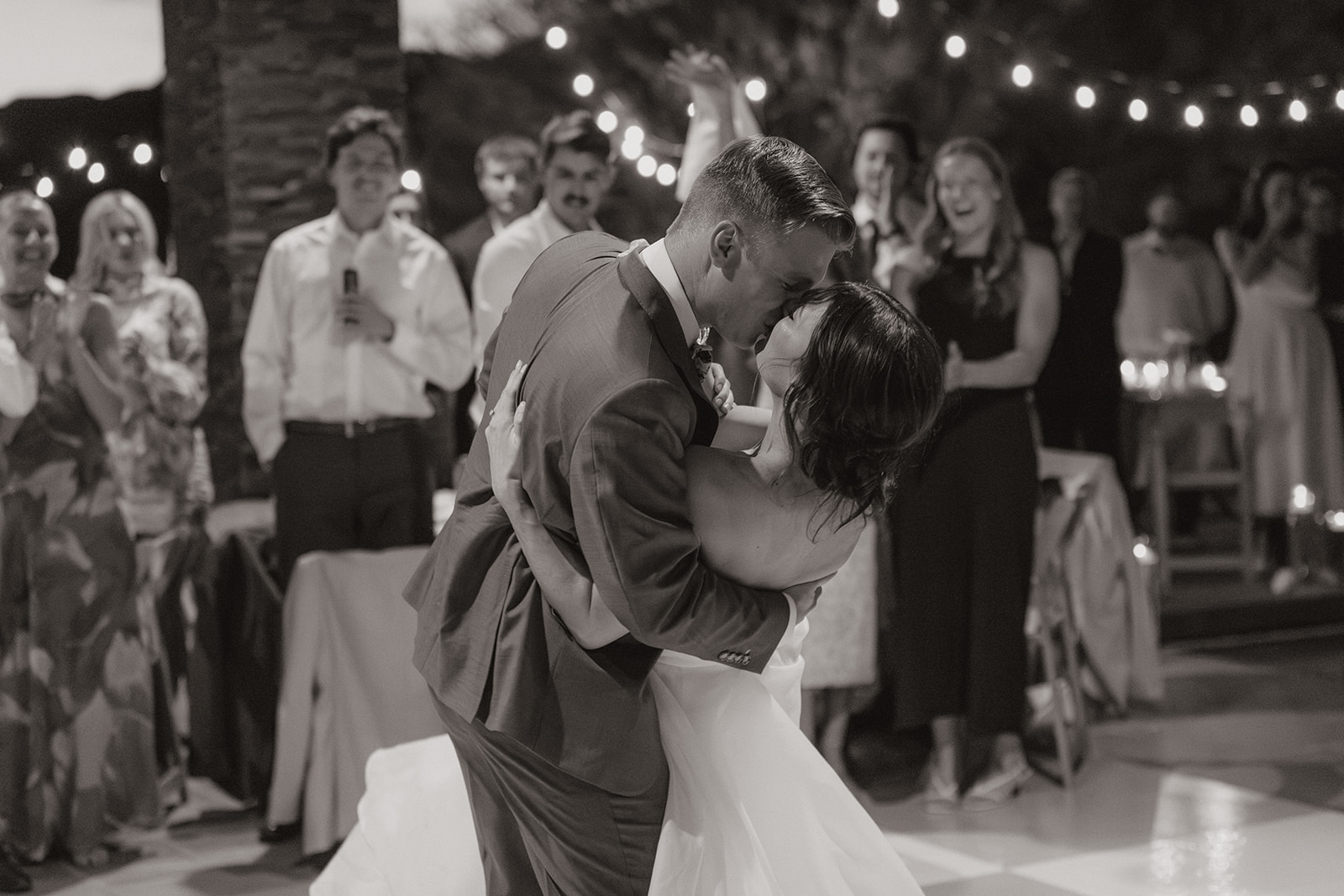 A bride and groom kissing on their wedding dance floor