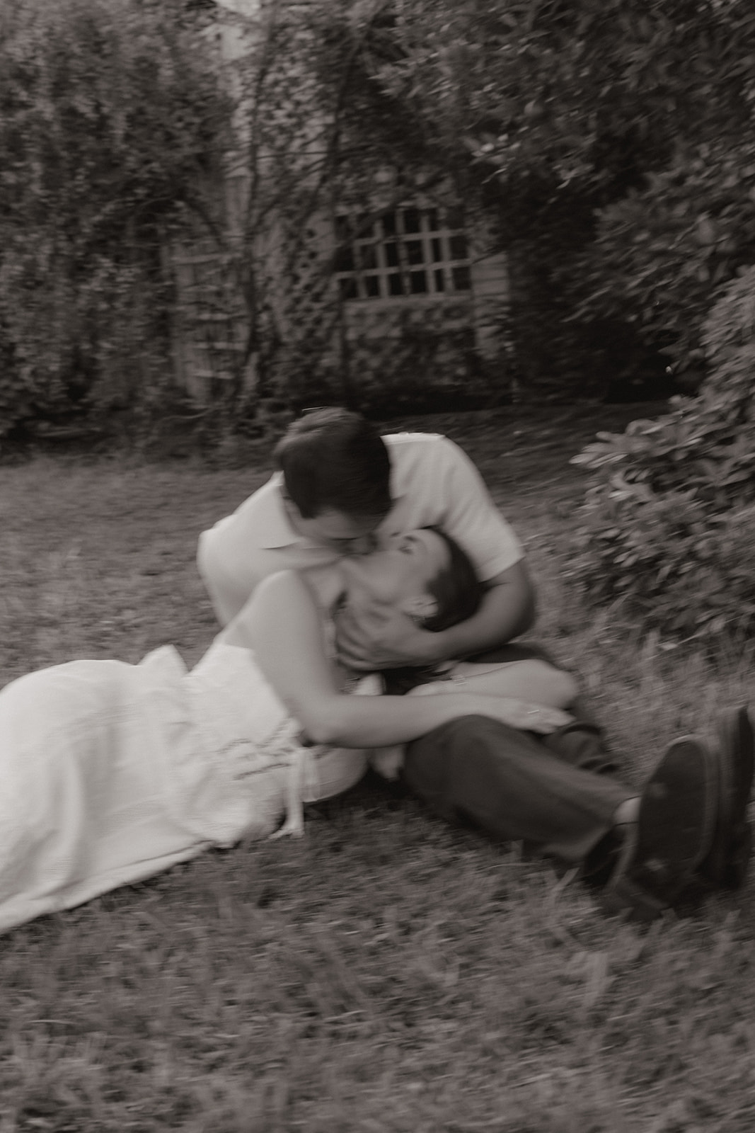 A blurry engagement photo of a couple kissing
