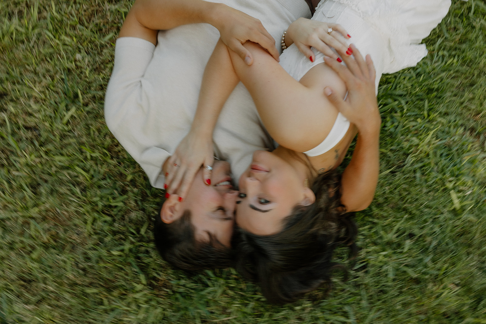 A couple in the grass for engagement photos