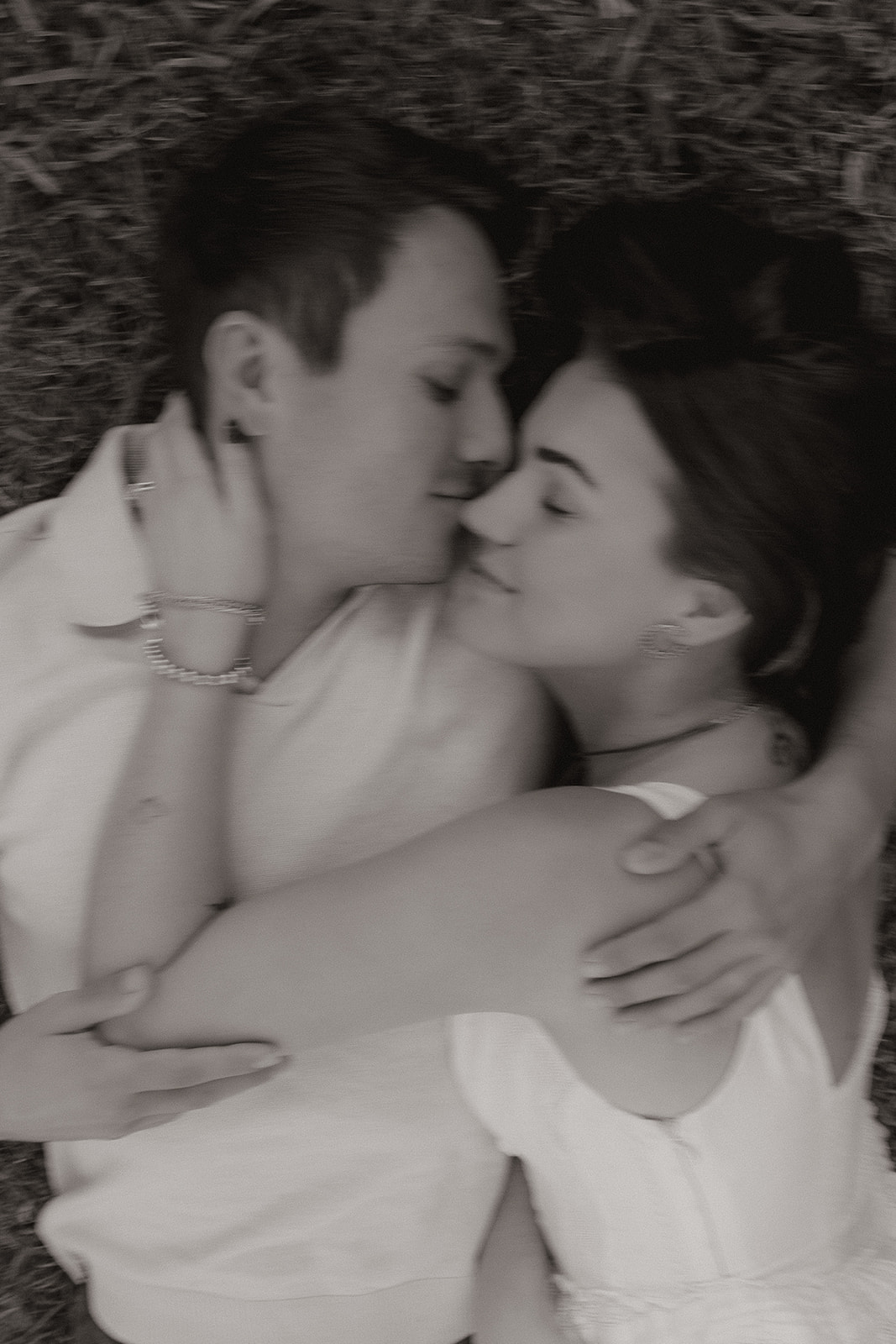A blurry engagement photo of a couple kissing