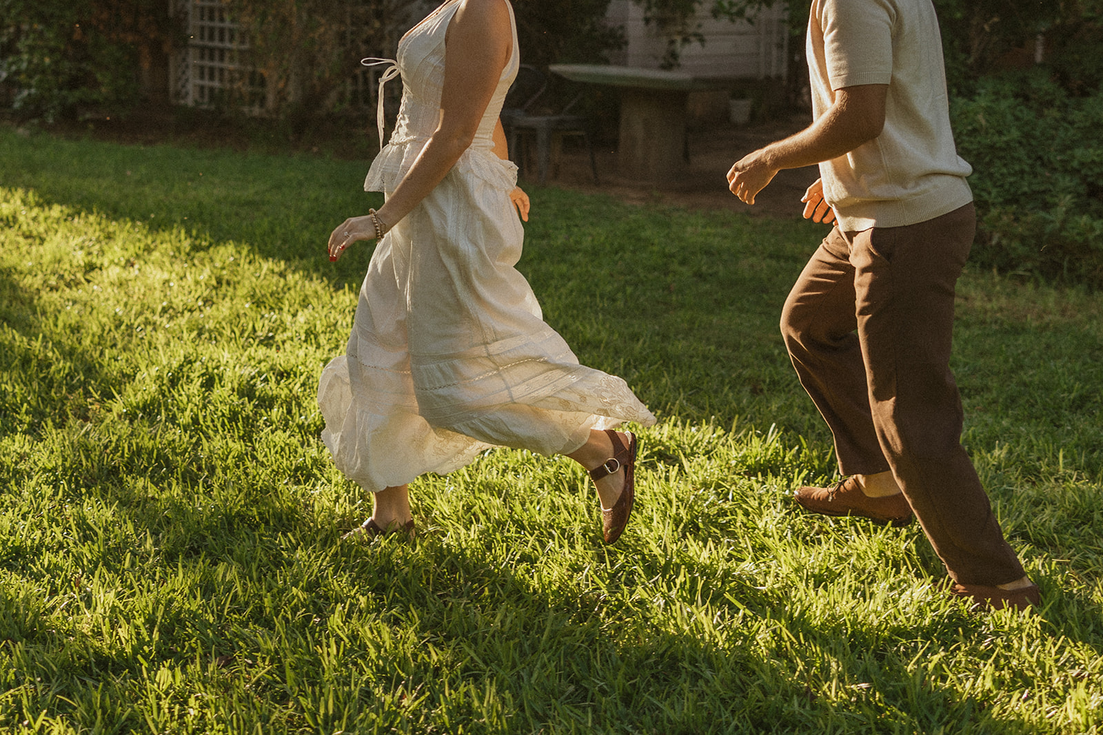 A couple running through the grass for their romantic engagement photos
