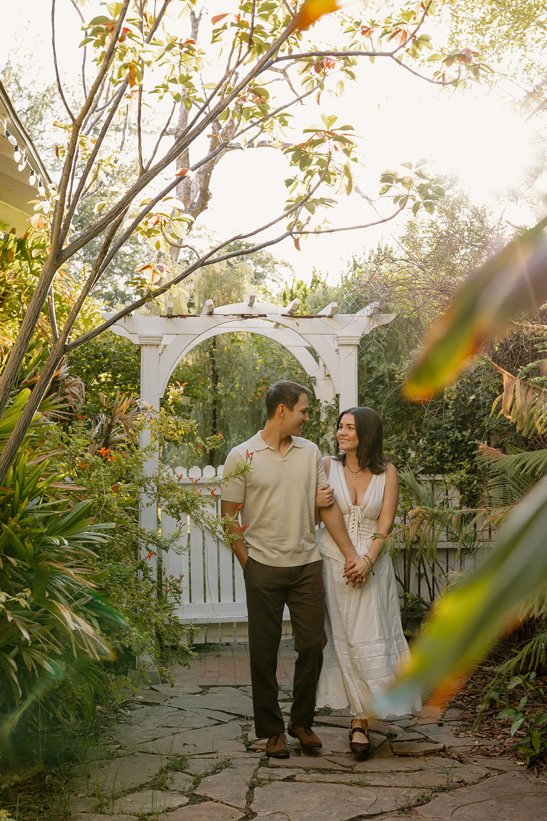 A couple taking garden engagement photos at the evergreen garden in Arizona