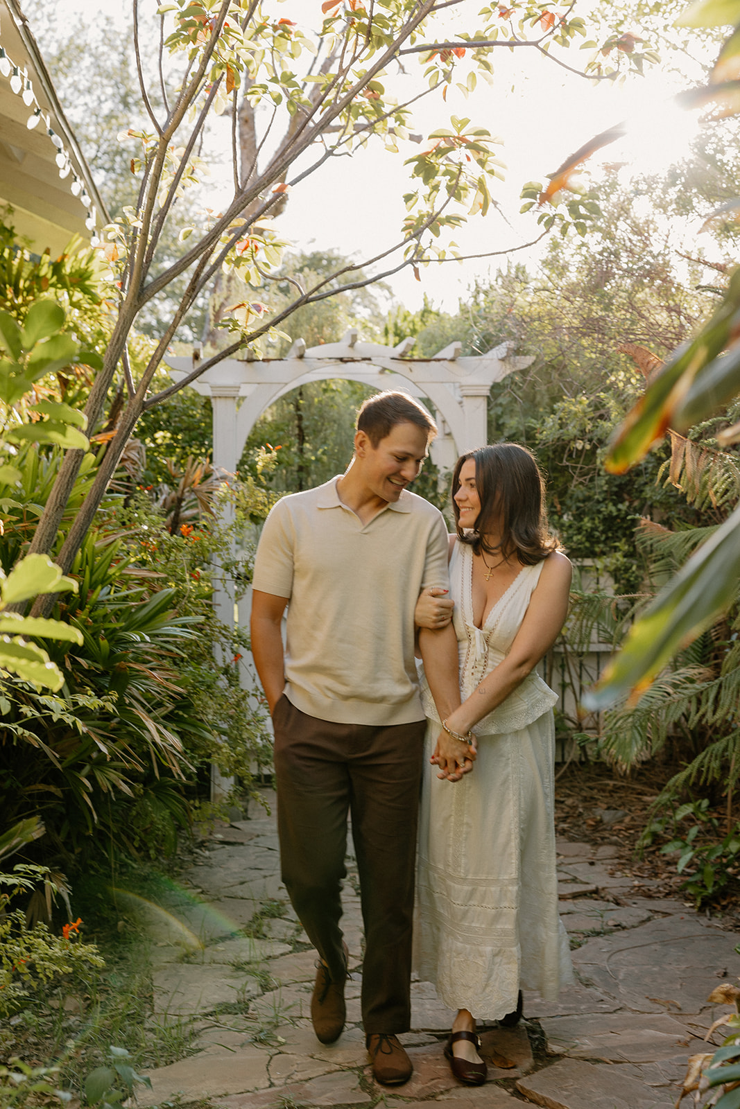A couple taking garden engagement photos at the evergreen garden in Arizona