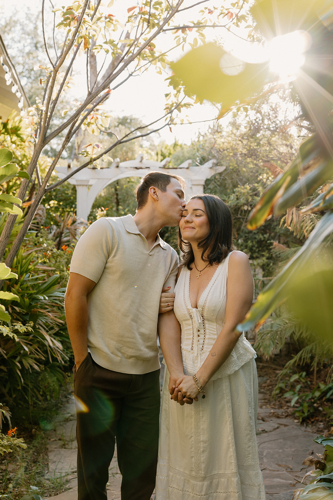 A couple taking garden engagement photos at the evergreen garden in Arizona