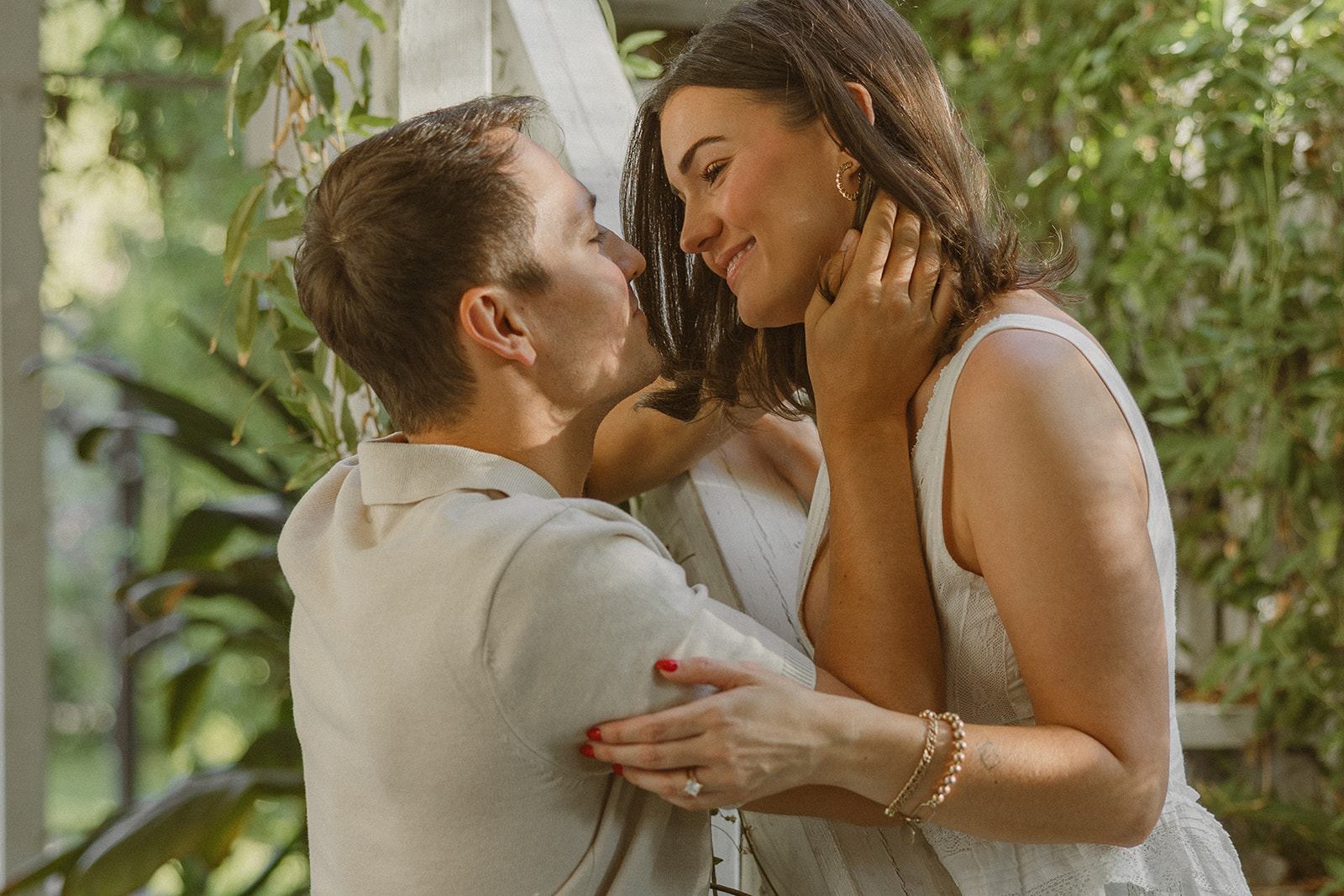A couple posing for garden engagement photos