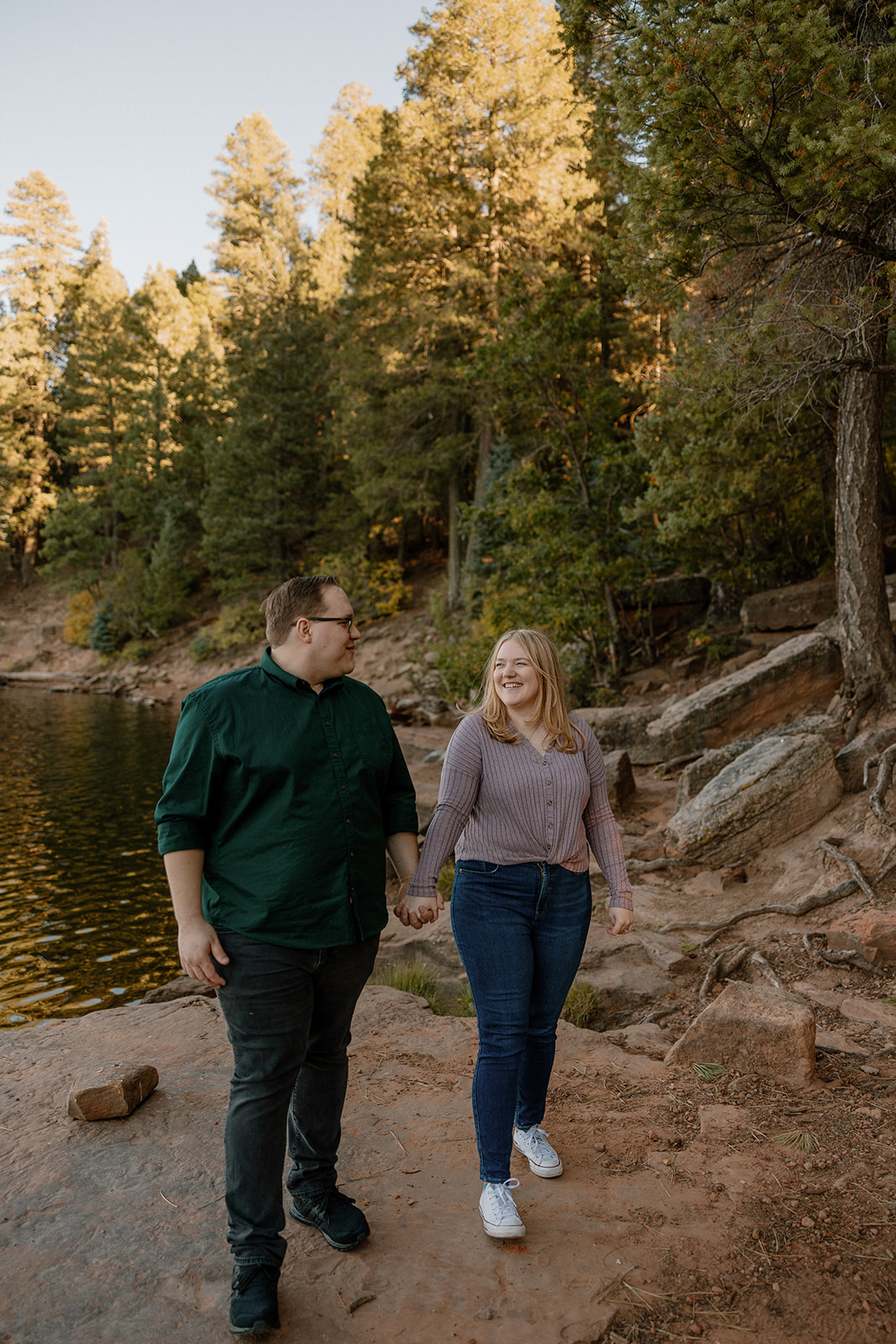 A couple posing for summer engagement photos at an engagement photo location on Payson