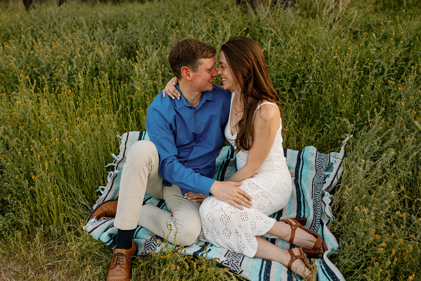 A couple on a picnic blanket for engagement photos