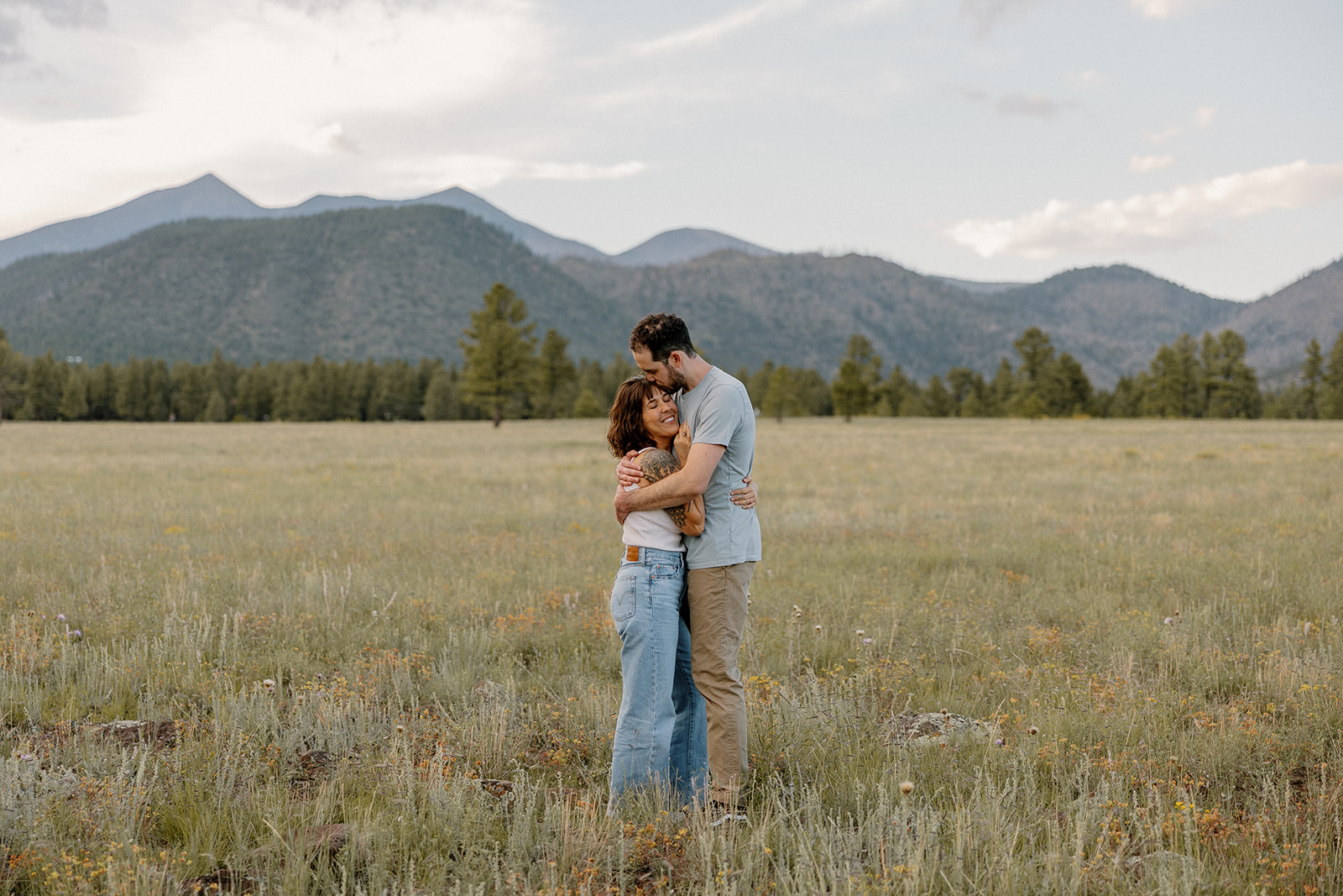 A couple hugging at their engagement photo location, Buffalo park