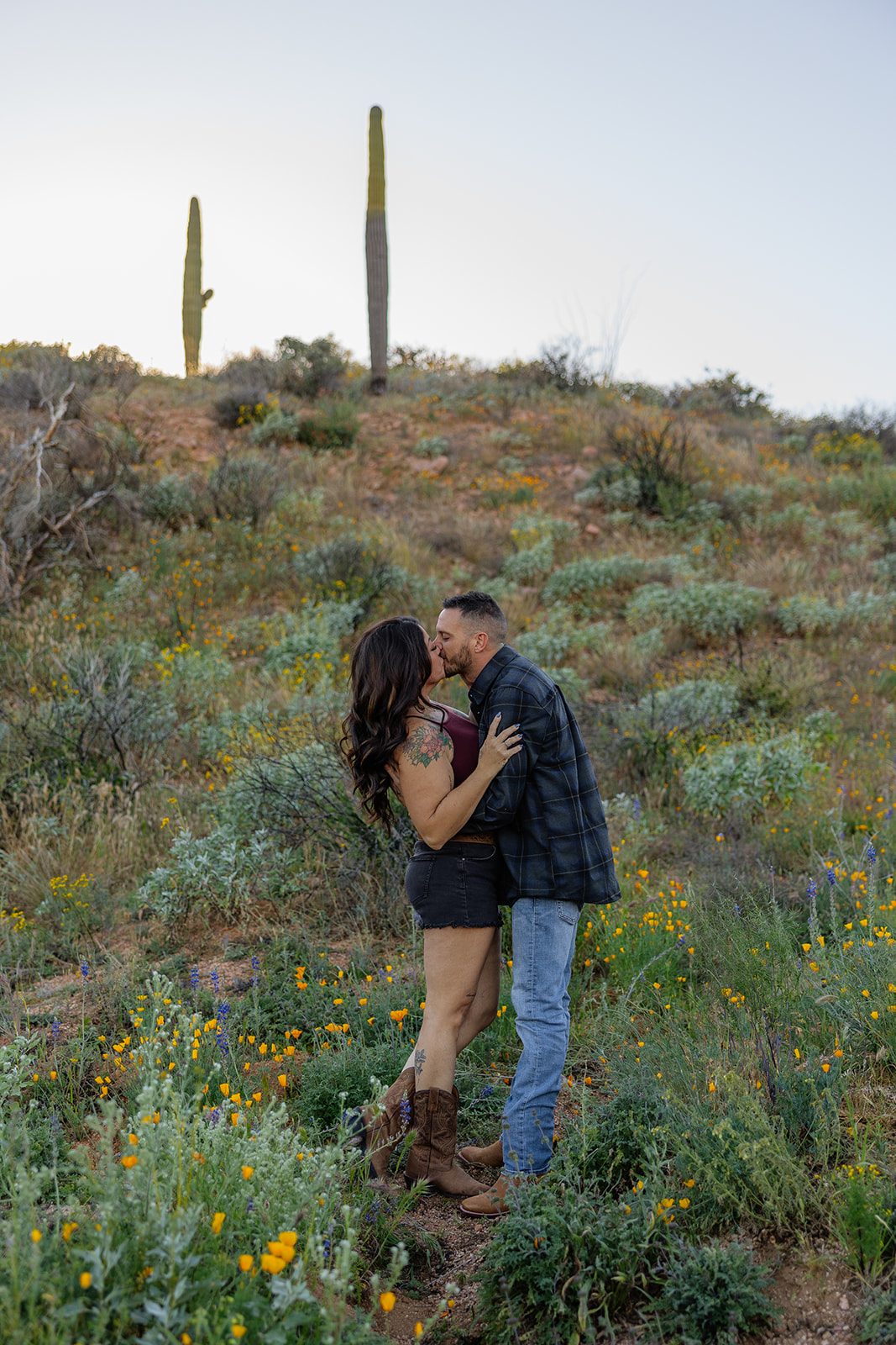 A couple taking engagement photos at Bartlett Lake in Arizona