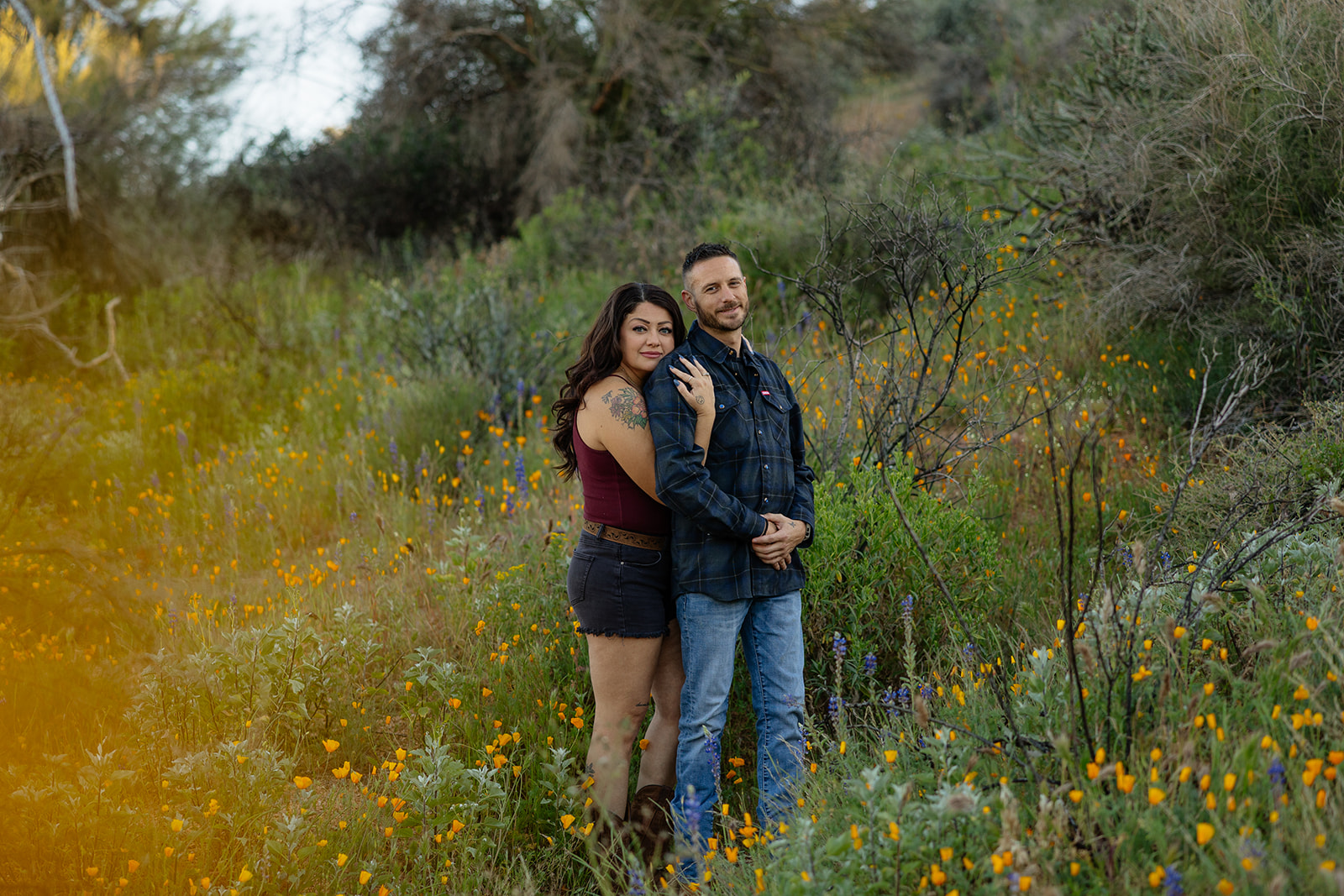 A couple in a flower field for engagement photos