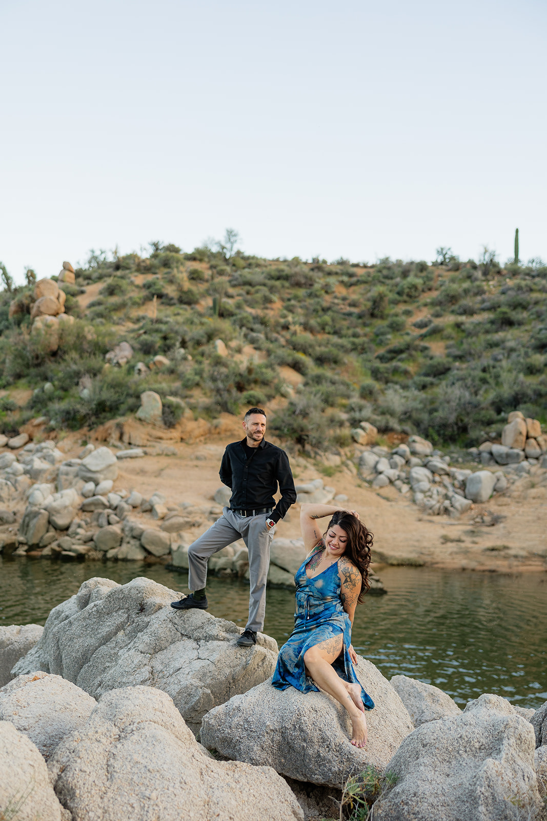 A couple posing for lake engagement photos at Bartlett Lake in Arizona